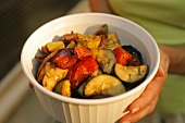 Woman Carrying a Serving Bowl of Grilled Vegetables