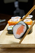 Maki sushi held in chopsticks