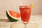 Watermelon Refresher in a Glass with Straw; Piece of Watermelon