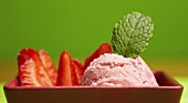Strawberry ice cream with fresh strawberries and mint