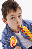 A little boy eating a giant lolly