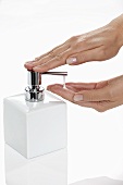 Liquid soap being pumped out of a soap dispenser