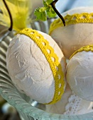 Easter eggs with yellow lace decorations