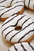 Iced donuts with chocolate stripes
