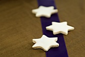 Three cinnamon stars on a purple stripe