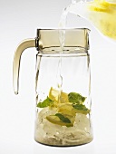 Filling a carafe with essence of lemonade