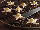 Nougat stars with hazel nuts on a cooling rack