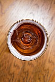 A glass of beer on a table (seen from above)