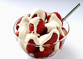 Strawberries in a glass bowl with cream
