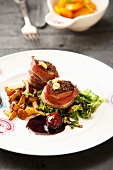 Beef fillet wrapped in bacon with chanterelle mushrooms and savoy cabbage