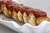 Curried sausage with ketchup (close-up)