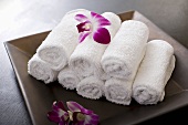 Rolled towels and orchid flowers