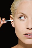 A woman with a cotton bud in her ear