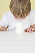 A boy smelling yoghurt
