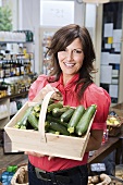 Woman in store with courgettes