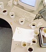 White coffee cups in front of a computer