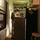 A man looking in a refrigerator