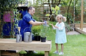 A father and daughter working in a garden