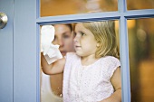 A girl cleaning a window