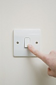 A finger on a light switch