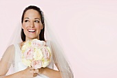 Smiling bride holding a bouquet