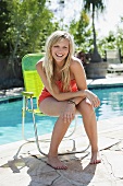 A young woman by the pool on holiday