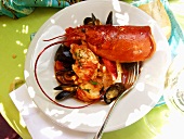 Creole lobster and mussel stew on table in open air