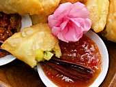 Fried filled pastries with spicy sauce
