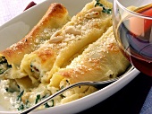 Cannelloni with spinach and pine nuts; red wine glass
