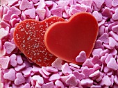 Red chocolate hearts on pink sugar hearts