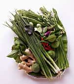 Asian vegetable still life with herbs, limes, ginger