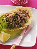 Minced duck with chili rings on Chinese cabbage leaf