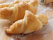 Freshly baked croissants on chopping board