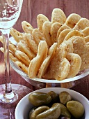 Parmesan hearts, green olives and champagne glass