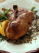 Roast legs of wild duck with herbs and lemon