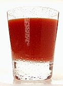 Tomato juice in glass with drops of water