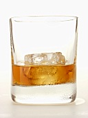 Whiskey with ice cubes in glass