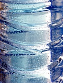 Drops of water on mineral water bottle (close-up)