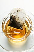 Used tea bag in teacup with spoon