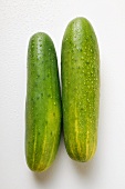 Two fresh cucumbers with drops of water