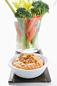 Carrot dip and raw vegetables in glass