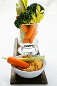 Celery, broccoli and carrots in glass; carrot dip