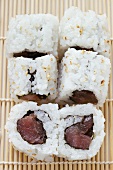 Inside-out rolls with tuna on bamboo mat