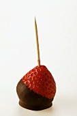 Chocolate-coated strawberry on toothpick
