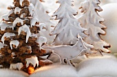 Winter forest scene with gingerbread trees and bird