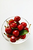 Fresh red cherries in glass bowl
