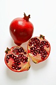 Whole pomegranate and two pomegranate halves