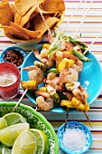 Mexican shrimp kebabs; limes; tortilla chips