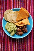 Tomato salsa and guacamole with tortilla chips
