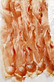 Slices of raw ham on paper